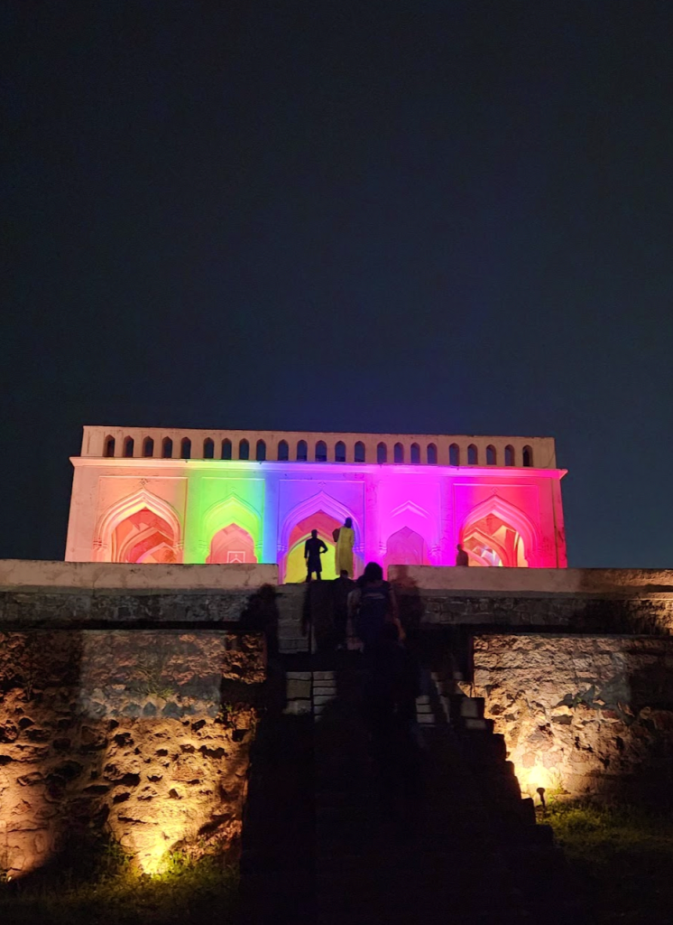 taramati baradari lit up in rainbow coloured lights in the evening