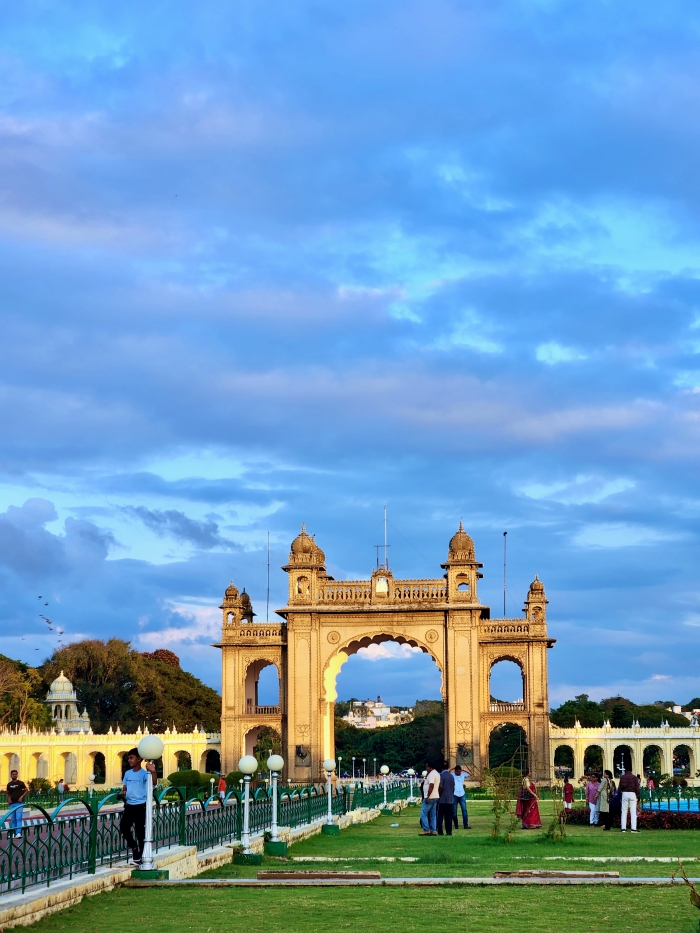 Jayamarthanda Gate located east of the mysore palace with magnificent arches and columns. It is set in the lawns in front of the palace and against a blue evening sky